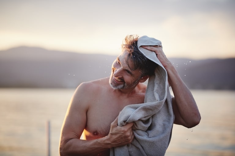 Man toweling himself at the lake